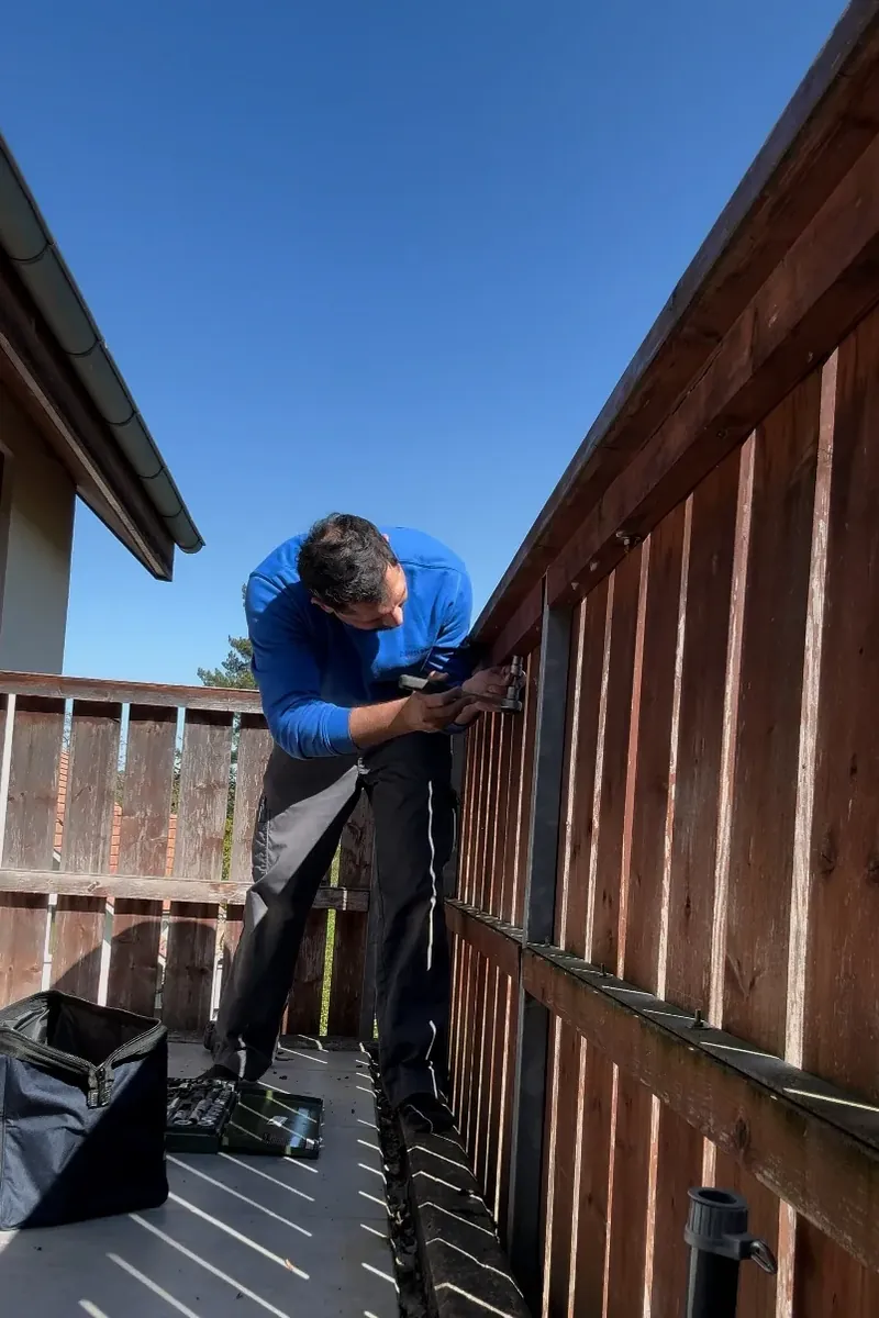 Arnel Zimmermann renovating a balcony railing