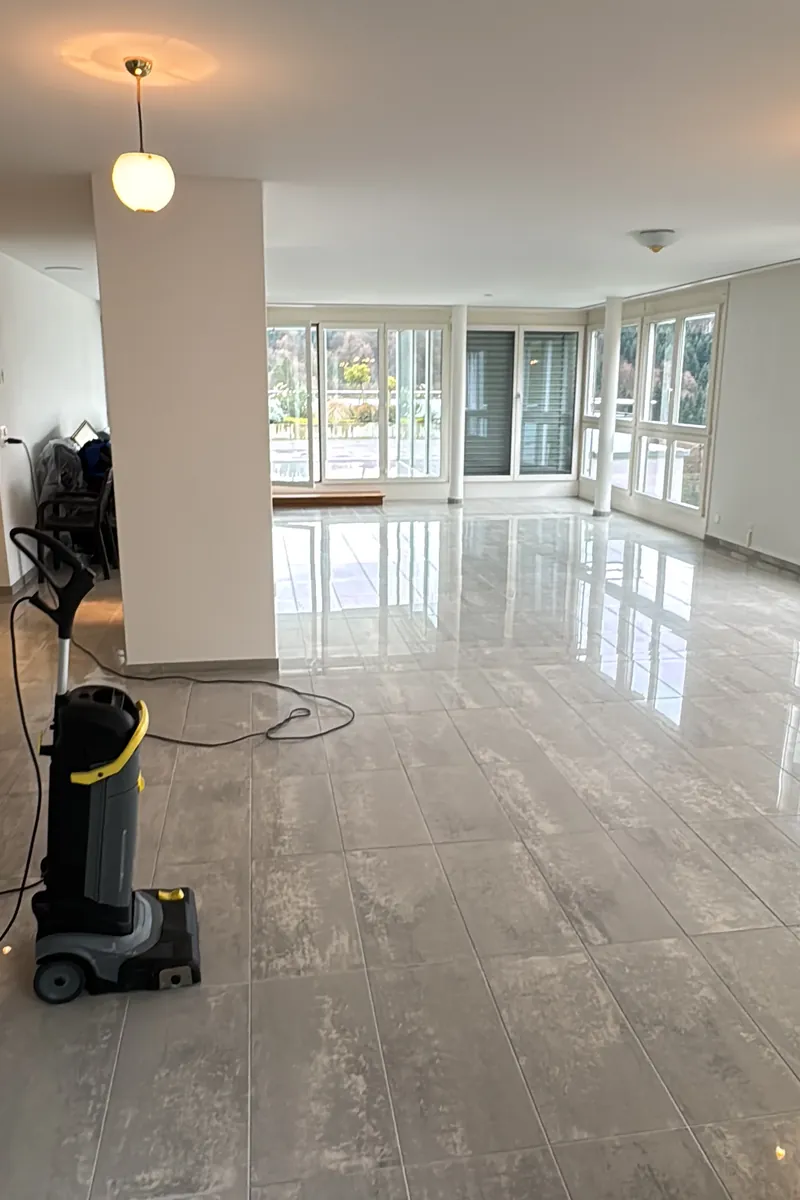 Bright cleaned room with floor-cleaning machine