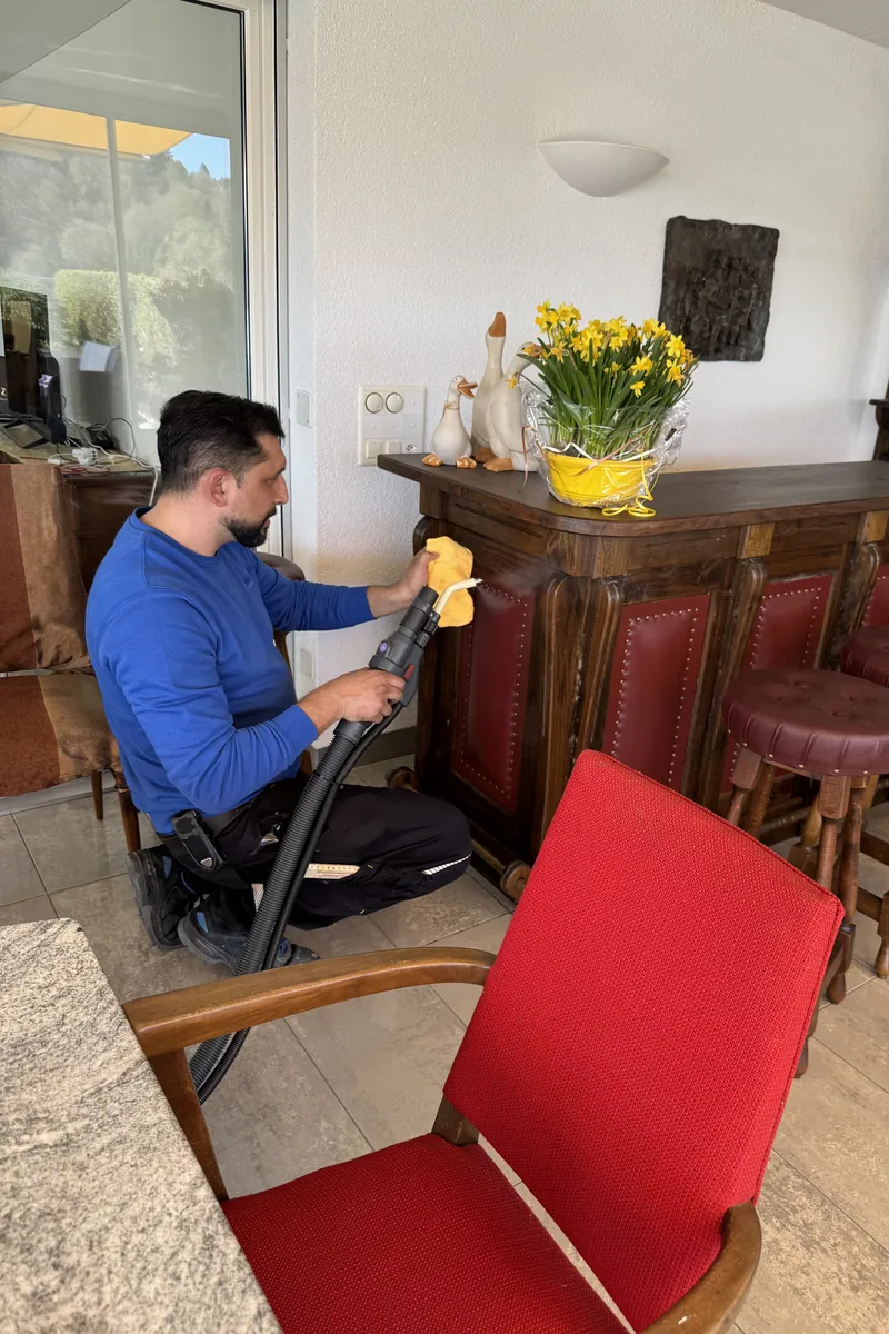 Arnel Zimmermann steam-cleaning a wooden counter