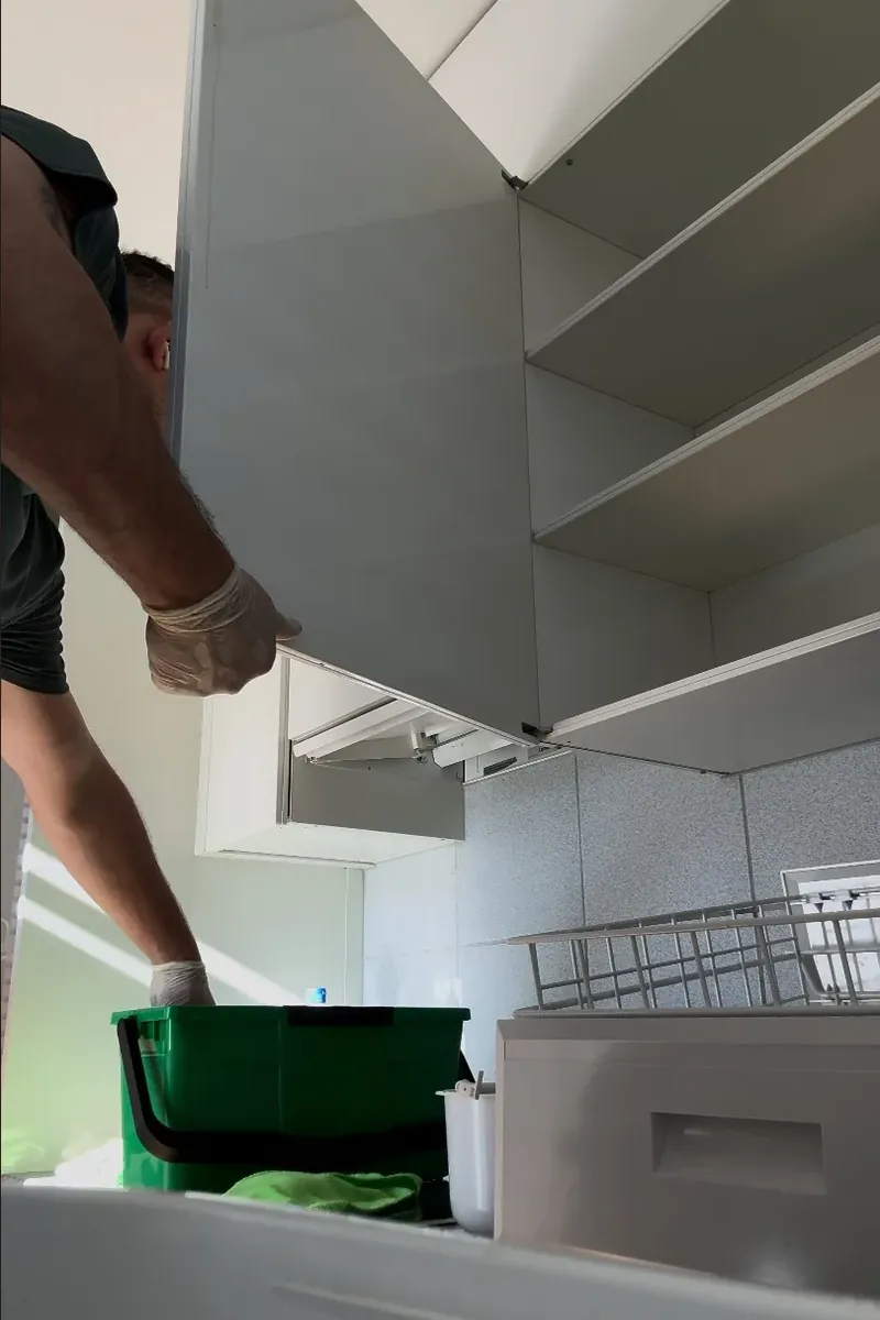 Cleaning inside a kitchen cabinet